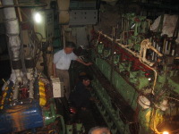 Technician working on diesel engine.